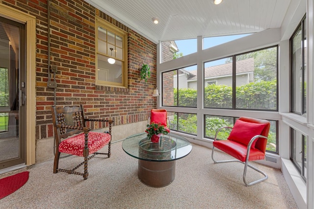 825 5th Ave SW, Faribault, MN 55021 - sunroom with vaulted ceiling, brick wall, and recessed lighting