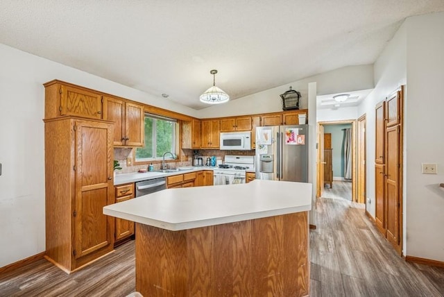 26343 10th St W, Zimmerman, MN 55398 - kitchen featuring white appliances, dark wood finished floors, light countertops, brown cabinetry, and vaulted ceiling