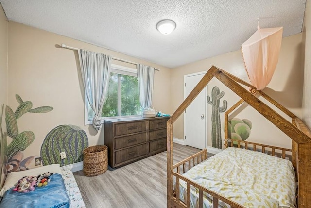 26343 10th St W, Zimmerman, MN 55398 - bedroom with light wood-style flooring and a textured ceiling