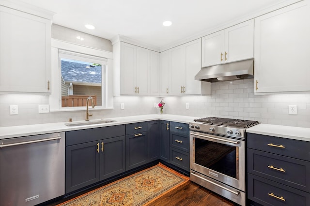 4810 42nd St, Saint Louis Park, MN 55416 - kitchen with stainless steel appliances, under cabinet range hood, white cabinetry, light countertops, and backsplash