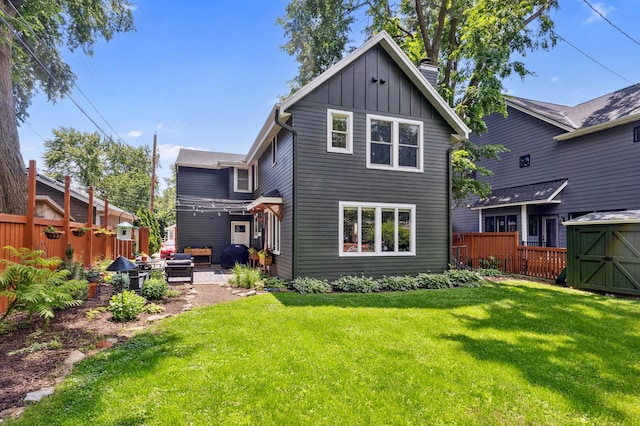 4810 42nd St, Saint Louis Park, MN 55416 - back of property featuring board and batten siding, a patio, a fenced backyard, and a chimney