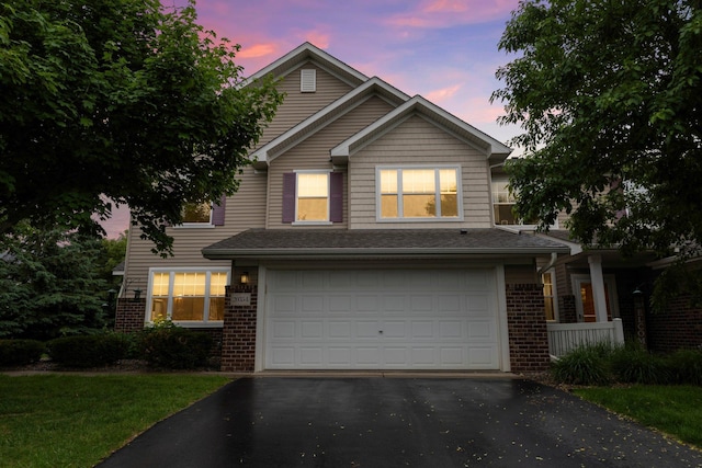20354 Kensfield Trl Unit 1403, Lakeville, MN 55044 - traditional-style home with brick siding, an attached garage, and asphalt driveway