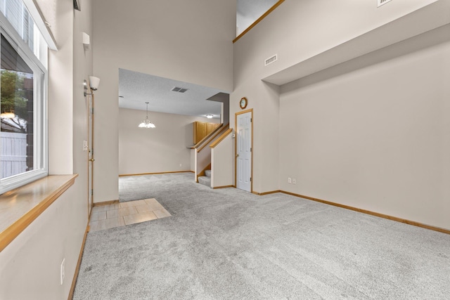 20354 Kensfield Trl Unit 1403, Lakeville, MN 55044 - entrance foyer with carpet floors, stairway, a high ceiling, and a chandelier