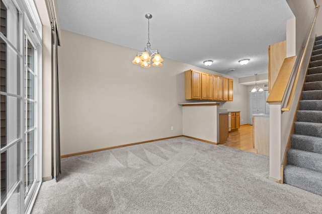 20354 Kensfield Trl Unit 1403, Lakeville, MN 55044 - unfurnished living room with a chandelier, stairs, light carpet, and a textured ceiling