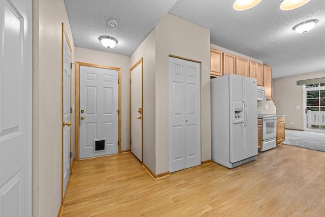 20354 Kensfield Trl Unit 1403, Lakeville, MN 55044 - kitchen featuring white appliances, a textured ceiling, light wood-type flooring, and light brown cabinetry