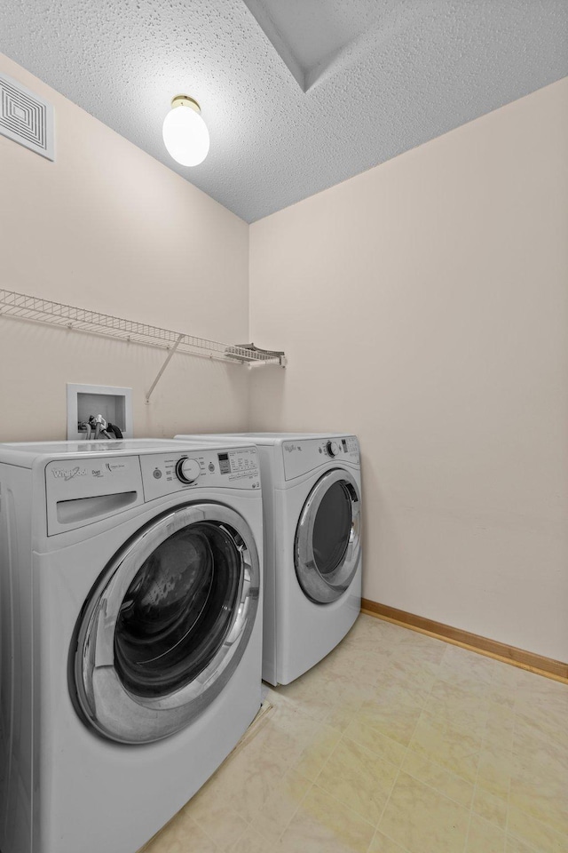20354 Kensfield Trl Unit 1403, Lakeville, MN 55044 - laundry area with washing machine and clothes dryer, light floors, and a textured ceiling