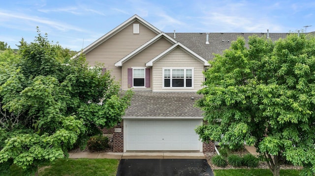 20354 Kensfield Trl Unit 1403, Lakeville, MN 55044 - view of front of house featuring a shingled roof, brick siding, asphalt driveway, and an attached garage