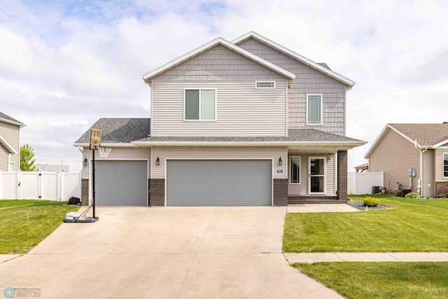 618 23rd Ave W, West Fargo, ND 58078 - view of front of property featuring brick siding, an attached garage, and driveway