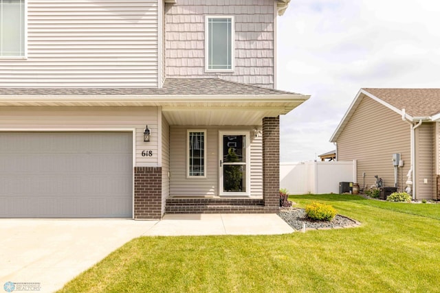 618 23rd Ave W, West Fargo, ND 58078 - view of front of house featuring brick siding, an attached garage, concrete driveway, a porch, and a shingled roof