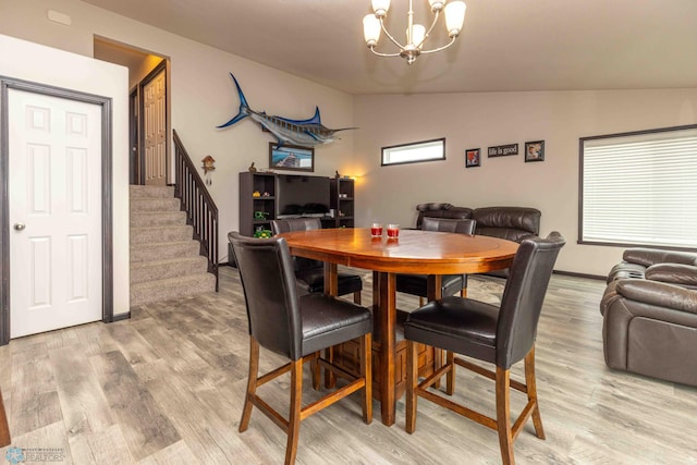 618 23rd Ave W, West Fargo, ND 58078 - dining area with a chandelier, light wood finished floors, stairway, and lofted ceiling