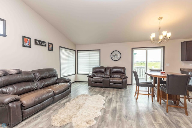 618 23rd Ave W, West Fargo, ND 58078 - living room featuring a chandelier, vaulted ceiling, and light wood-style floors