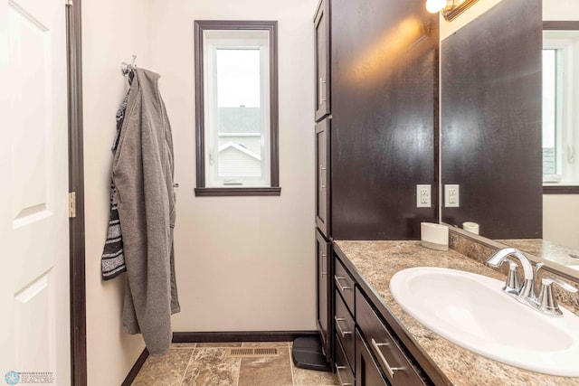 618 23rd Ave W, West Fargo, ND 58078 - bathroom featuring healthy amount of natural light, vanity, and stone finish flooring