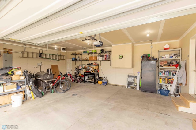 618 23rd Ave W, West Fargo, ND 58078 - garage featuring fridge, electric panel, and a garage door opener