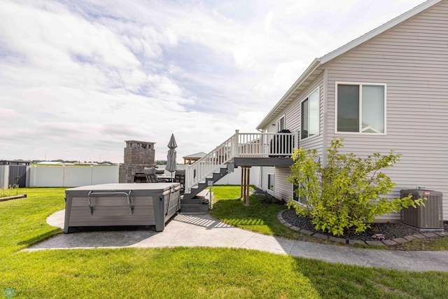 618 23rd Ave W, West Fargo, ND 58078 - view of yard with a hot tub, stairs, a wooden deck, and a patio