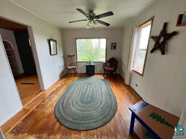 355 Harvey St, Ely, MN 55731 - sitting room with wood finished floors, crown molding, and ceiling fan