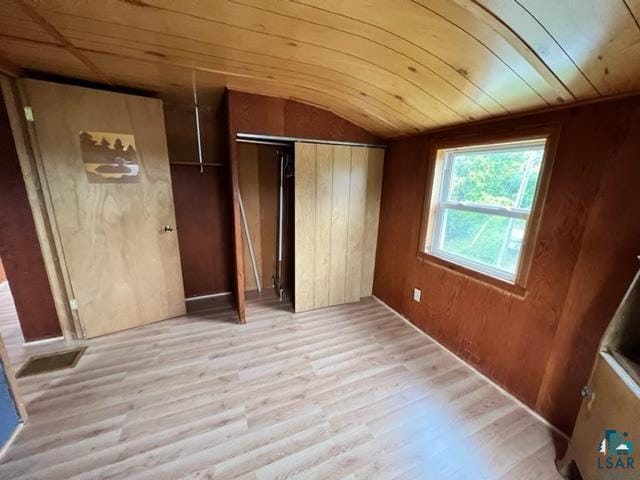 355 Harvey St, Ely, MN 55731 - unfurnished bedroom with light wood-style flooring, vaulted ceiling, and a closet