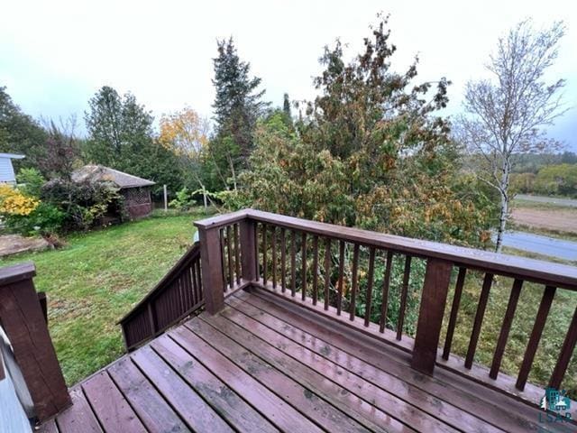 355 Harvey St, Ely, MN 55731 - wooden deck featuring a yard