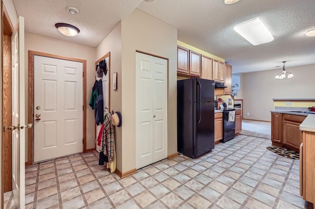 11182 204th St W Unit 908, Lakeville, MN 55044 - kitchen featuring black appliances, a textured ceiling, under cabinet range hood, light countertops, and pendant lighting