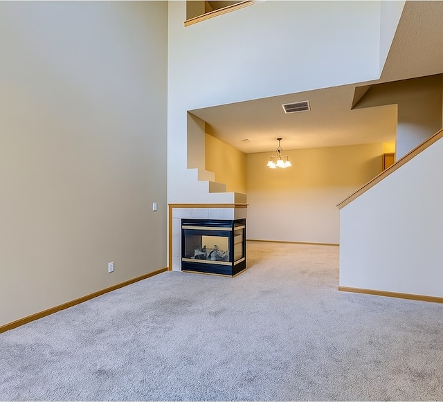 11182 204th St W Unit 908, Lakeville, MN 55044 - unfurnished living room featuring carpet flooring, a multi sided fireplace, a chandelier, and stairway