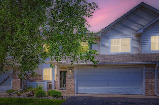 11182 204th St W Unit 908, Lakeville, MN 55044 - view of front of house featuring an attached garage, brick siding, and driveway