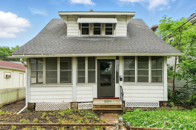976 Forest St, Saint Paul, MN 55106 - bungalow-style home with a shingled roof, entry steps, and a sunroom