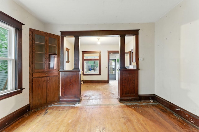 976 Forest St, Saint Paul, MN 55106 - empty room with light wood-style floors, plenty of natural light, and ornate columns