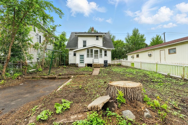 976 Forest St, Saint Paul, MN 55106 - back of property featuring entry steps, a fenced backyard, and a chimney