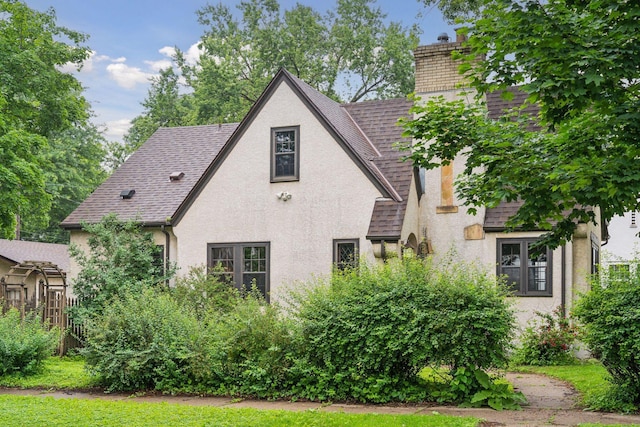 300 Diamond Lake Rd, Minneapolis, MN 55419 - back of property featuring a chimney, stucco siding, and a shingled roof