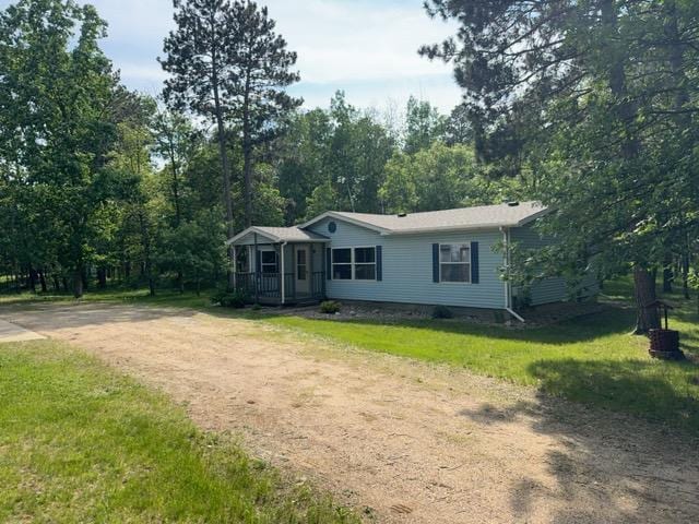 19531 Explorer Trl, Todd Twp, MN 56470 - manufactured / mobile home with a front lawn, dirt driveway, and covered porch