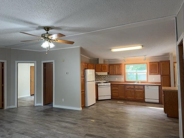 19531 Explorer Trl, Todd Twp, MN 56470 - kitchen with white appliances, dark wood-style flooring, ceiling fan, brown cabinets, and under cabinet range hood