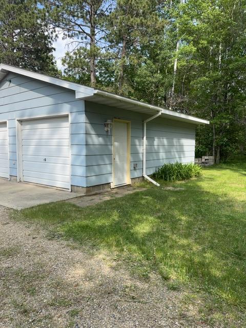 19531 Explorer Trl, Todd Twp, MN 56470 - view of front of property featuring a garage, an outbuilding, and a front lawn