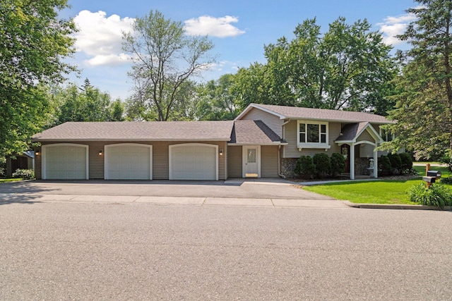 723 2nd Ave S, Buffalo, MN 55313 - view of front of house with an attached garage, asphalt driveway, and roof with shingles