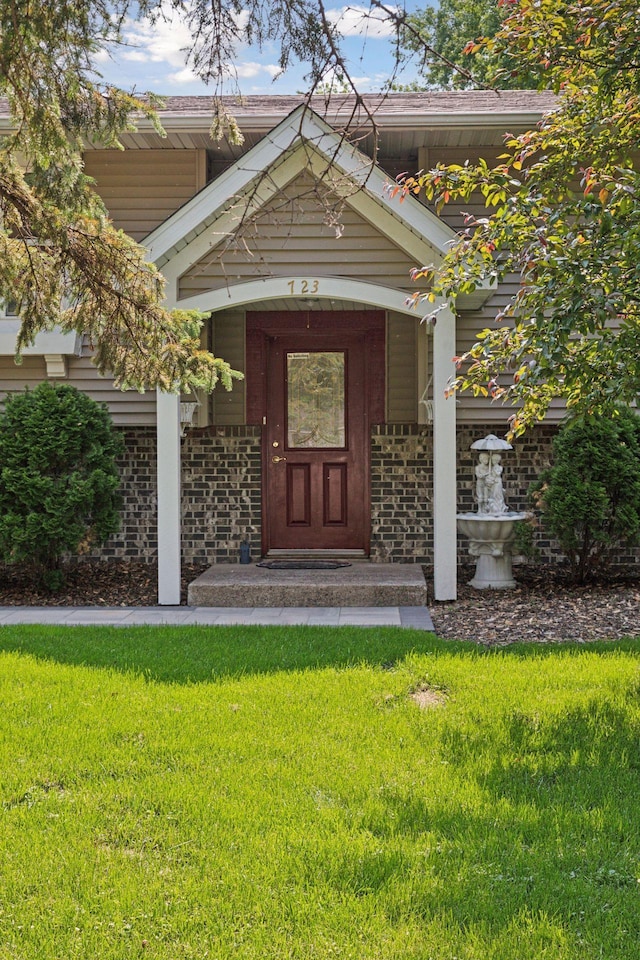 723 2nd Ave S, Buffalo, MN 55313 - doorway to property with a yard and brick siding
