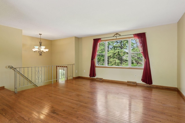 723 2nd Ave S, Buffalo, MN 55313 - unfurnished room with a chandelier and hardwood / wood-style floors