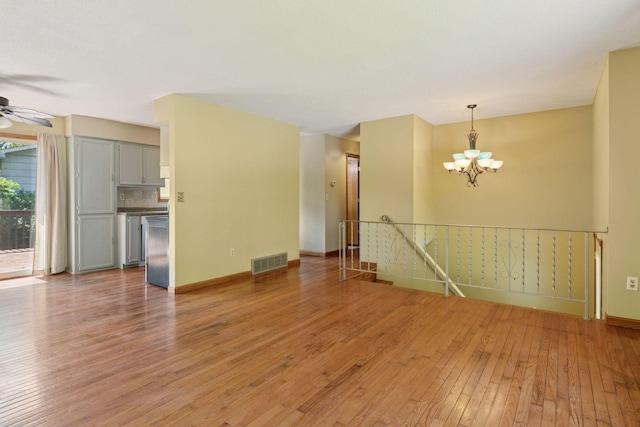 723 2nd Ave S, Buffalo, MN 55313 - spare room featuring light wood-style flooring, a chandelier, and a ceiling fan
