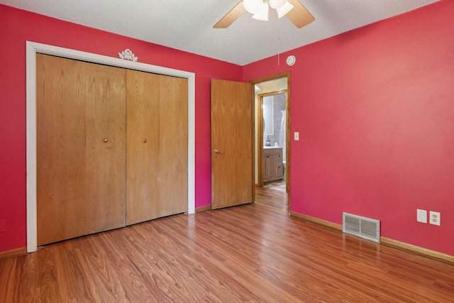 723 2nd Ave S, Buffalo, MN 55313 - unfurnished bedroom featuring wood finished floors, a closet, and a ceiling fan