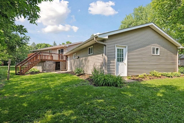 723 2nd Ave S, Buffalo, MN 55313 - rear view of property with stairs, a deck, and a yard