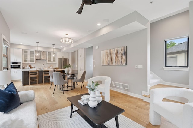 2820 Saint Louis Ave, Minneapolis, MN 55416 - living area with light wood finished floors, recessed lighting, ceiling fan, and stairs