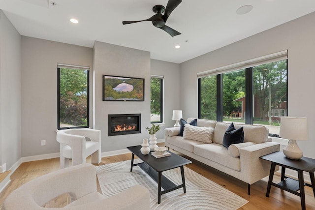 2820 Saint Louis Ave, Minneapolis, MN 55416 - living room with a large fireplace, light wood-style floors, ceiling fan, and recessed lighting