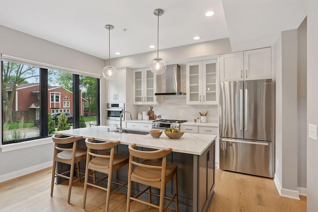 2820 Saint Louis Ave, Minneapolis, MN 55416 - kitchen with appliances with stainless steel finishes, wall chimney range hood, white cabinets, backsplash, and light wood-style floors