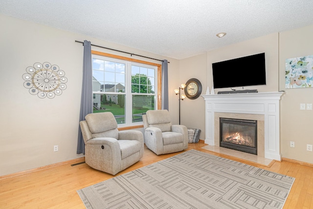 15265 Dupont Path, Apple Valley, MN 55124 - living room with wood finished floors, a high end fireplace, and a textured ceiling