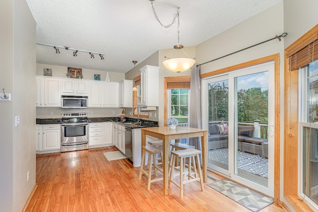 15265 Dupont Path, Apple Valley, MN 55124 - kitchen featuring appliances with stainless steel finishes, white cabinets, light wood-style floors, and a textured ceiling