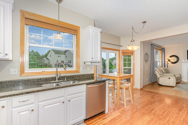 15265 Dupont Path, Apple Valley, MN 55124 - kitchen with stainless steel dishwasher, light wood-style flooring, white cabinets, pendant lighting, and a textured ceiling
