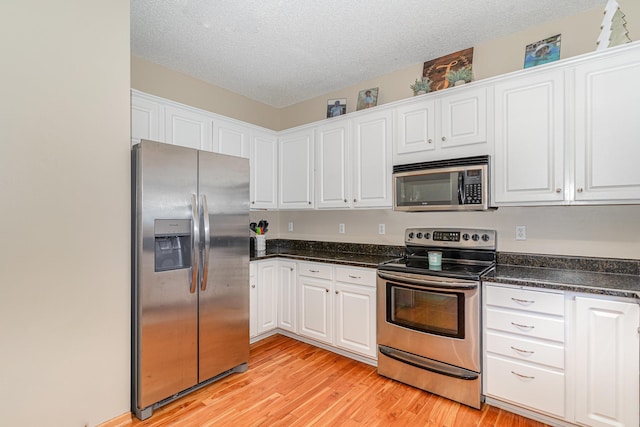15265 Dupont Path, Apple Valley, MN 55124 - kitchen featuring stainless steel appliances, white cabinetry, light wood-type flooring, and a textured ceiling