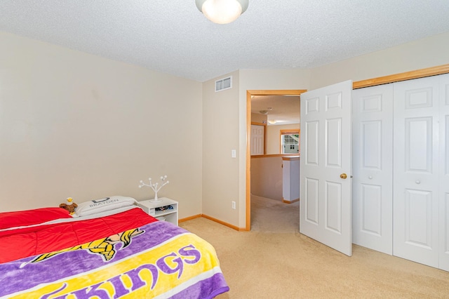 15265 Dupont Path, Apple Valley, MN 55124 - bedroom with light carpet, a closet, and a textured ceiling