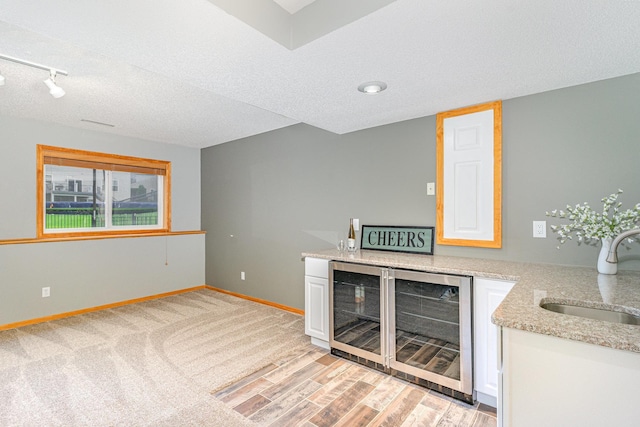 15265 Dupont Path, Apple Valley, MN 55124 - indoor dry bar with wine cooler, a textured ceiling, and rail lighting