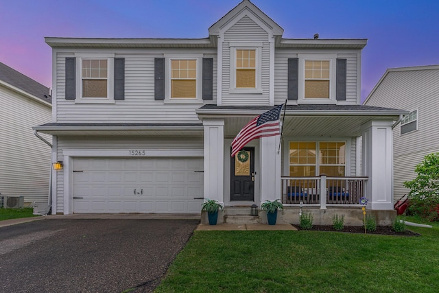 15265 Dupont Path, Apple Valley, MN 55124 - traditional-style house with a porch, asphalt driveway, an attached garage, and a front yard
