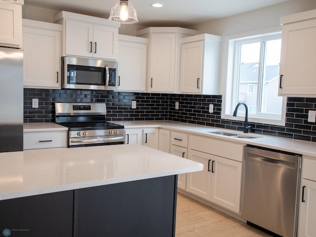 7901 Lost River Rd, Horace, ND 58047 - kitchen with appliances with stainless steel finishes, white cabinetry, recessed lighting, light wood-style floors, and tasteful backsplash