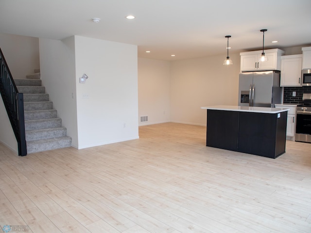 7901 Lost River Rd, Horace, ND 58047 - kitchen featuring appliances with stainless steel finishes, light countertops, white cabinets, recessed lighting, and decorative backsplash