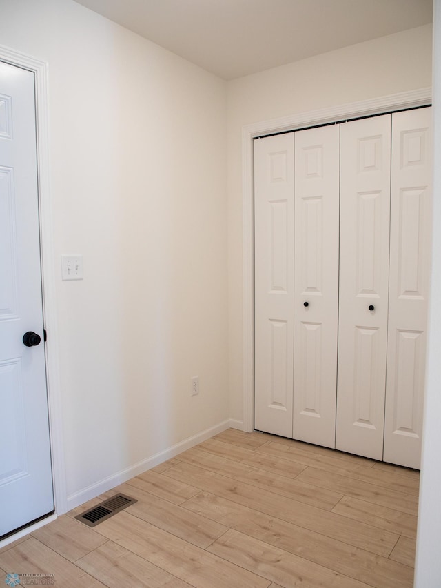 7901 Lost River Rd, Horace, ND 58047 - unfurnished bedroom featuring light wood-style flooring and a closet